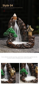 Macro view of backflow incense burner showing white smoke flowing down rocky mountain terrain