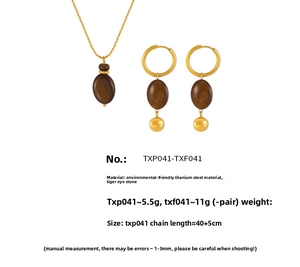Macro view of gold titanium necklace and earrings set with lucky tiger eye stones