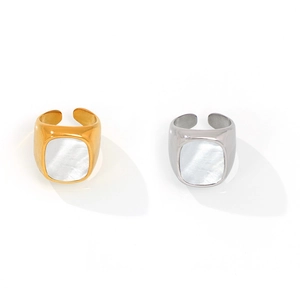 Elegant gold and silver titanium rings with white mother of pearl inlay on white background