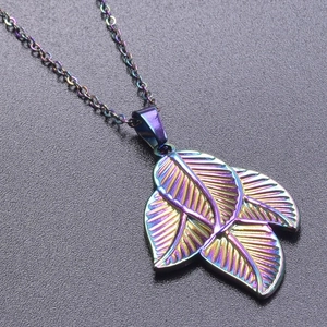 Macro shot of 18k rainbow plated stainless steel triple leaf pendants on a metal chain