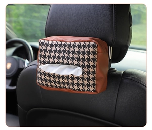 Detail of knitted houndstooth tissue box showing leather trim on car headrest