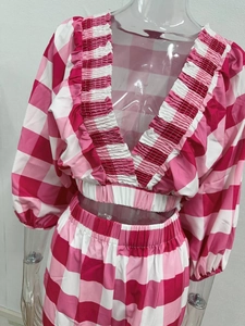 Detailed view of pink gingham two-piece set with V-neck cropped top and ruffle edges