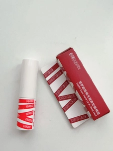 Close-up of matte lip and cheek mud with minimalist white packaging and red branded box