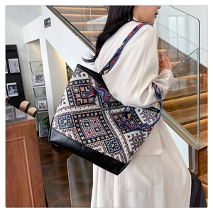 Ethnic style tote bag featuring colorful geometric woven patterns and black PU leather base