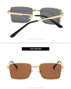 Detail view of vintage square metal sunglasses with black and brown lenses in gold frames