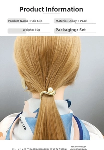Detail of wavy golden alloy ponytail clip with a white pearl on a model head model