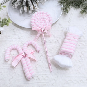 Pink and white plush candy cane Christmas tree ornaments with ribbon bows and gems