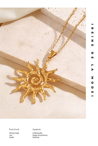 Macro shot of sun pendant necklace with hammered gold texture on silk and stone