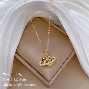 Detailed specs of the gold planet pendant necklace with sparkling rhinestones on silk