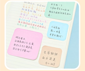 Close-up of pastel macaron sticky notes set on notebook for office and school use