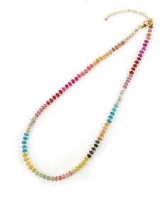 Detail of colorful beaded necklace with golden metal spacers and adjustable lobster clasp