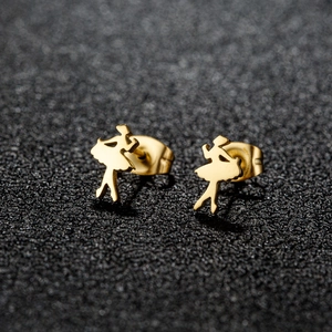 Macro shot of gold ballerina stud earrings with butterfly backs on black textured surface