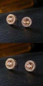 Detailed macro view of golden stud earrings featuring amber stone and white zircon halo