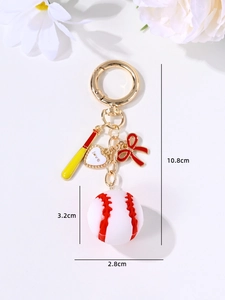 Detail of baseball keychain with bat, red bow, heart charm and 10.8cm size markings