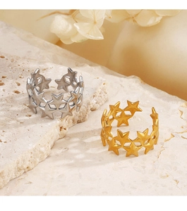 Detail of gold and silver stainless steel open rings with hollow star pattern design