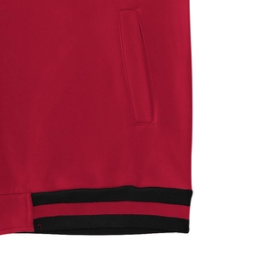 Detail of red baseball jacket showing ribbed hem with black stripes and pocket stitching