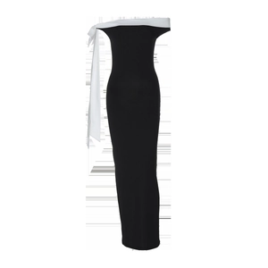 Detail of off-shoulder black slim dress featuring a large white bow on the neckline