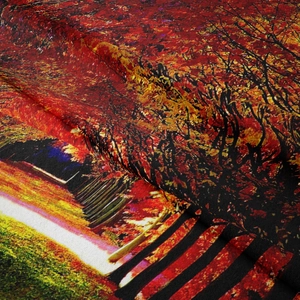 Detail of the soft woven fabric showing autumn forest landscape print and texture