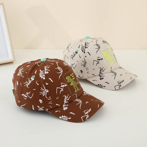 Detail of kids dinosaur print baseball caps in dark brown and beige cotton canvas fabric