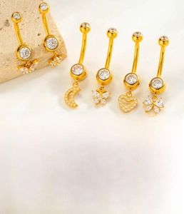 Close-up of G23 titanium belly button ring with zircon butterfly and heart pendants