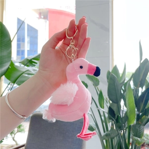 Cute pink flamingo plush keychain with golden metal clasp and white feather details