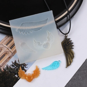 Silicone mold detail showing wing and heart shapes with resin pendant examples
