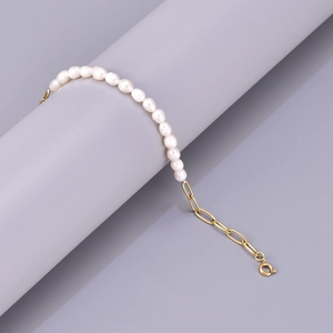 Detail view of freshwater pearls and 18K gold-plated stainless steel chain bracelet