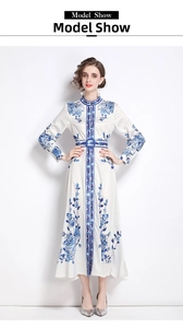 Detail of blue floral porcelain print on a white long-sleeved dress with matching belt