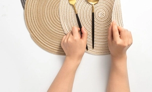 Detailed close-up of woven round placemats in beige, light brown, and dark brown shades