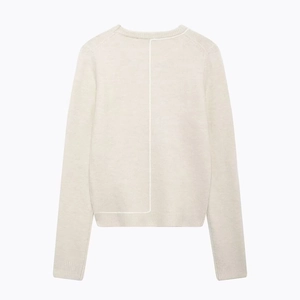 Minimalist cream knit sweater featuring distinctive back seam line and crew neck design