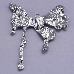 Macro view of silver 304 stainless steel butterfly pendant with unique molten texture