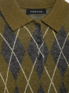 Close-up of olive green diamond pattern knit polo collar and button texture details