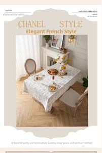 Close-up of French linen tablecloth featuring elegant vintage scrolls and jacquard texture