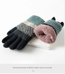 Detail of navy knit gloves with thick pink fleece lining and ribbed wrist cuffs