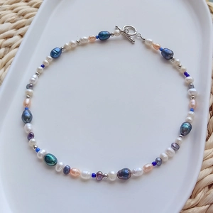 Macro shot of colorful irregular pearls and silver beads with T-bar closure necklace