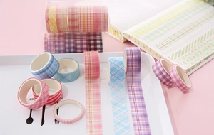 Close-up of colorful grid and stripe washi tapes on notebook for DIY scrapbooking craft