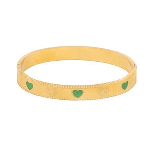 Vintage gold stainless steel bangle with green enamel hearts and embossed patterns