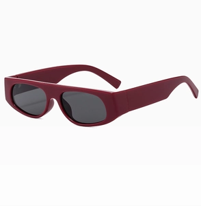 Detail shot of wine red rectangular sunglasses frame with thick temples and gray lenses