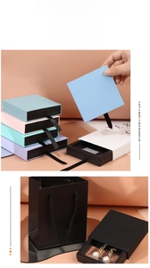 Macro detail of multi-color drawer jewelry boxes with ribbon handles and gift bags