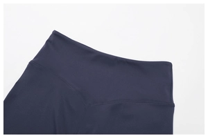 Detail of high waisted yoga shorts featuring a V-shaped back seam and matte elastic fabric