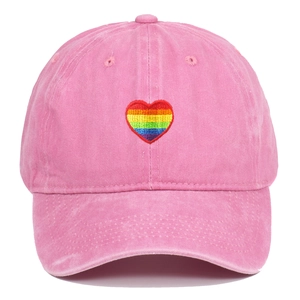 Pink washed cotton baseball cap featuring rainbow heart embroidery on a white background