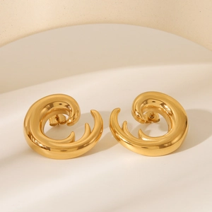 Detailed view of gold spiral C-shape earrings with a textured geometric metallic finish