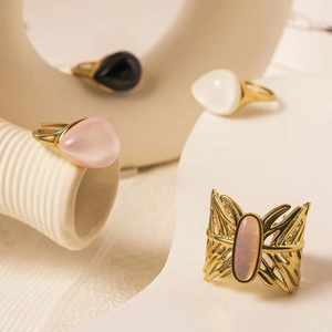 Detailed shot of gold plated oval and teardrop moonstone rings with a butterfly motif