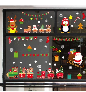 Close-up of festive Christmas window stickers with Santa, reindeer and penguins on glass