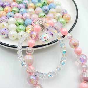 Pink and clear checkered acrylic beads phone strap with rainbow luster bear charm