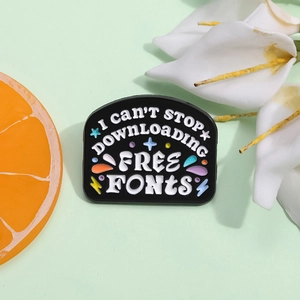 Black enamel badge with Free Fonts text, colorful stars and lightning icons on green base