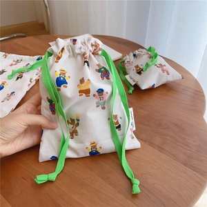 Detail of drawstring cotton pouch featuring cute bear prints and green woven cord