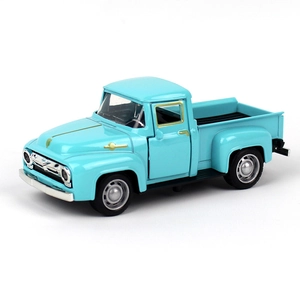 Detailed close-up of a vintage blue alloy pickup truck model with golden trim