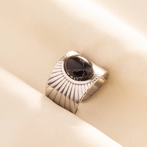 Macro detail of wide vintage 304 stainless steel ring with black marble stone inlay