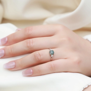 Elegant S925 silver open ring featuring green moss agate stone on a model hand